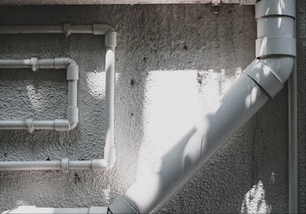 High-pressure hydro jetting nozzle clearing buildup inside a sewer line